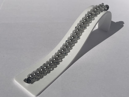 Closeup image of bracelet on white stand