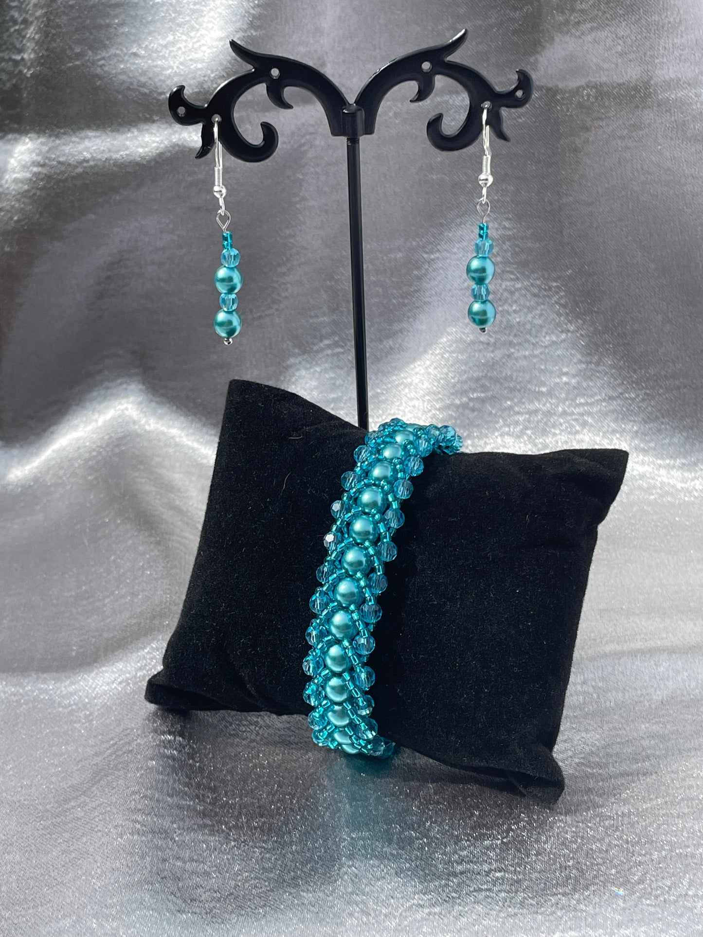 Teal pearl and crystal bracelet shown with matching earrings