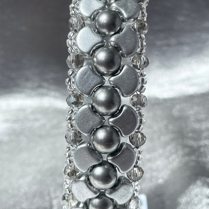 Close up of Silver Czech glass and crystal bead bracelet with silver satin background